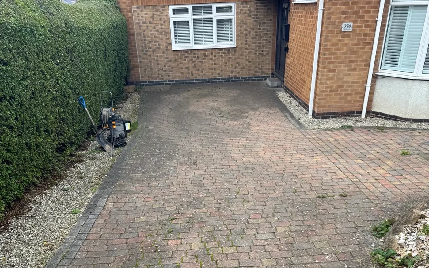 Block paved path and patio in Nottingham covered in moss and green algae before cleaning